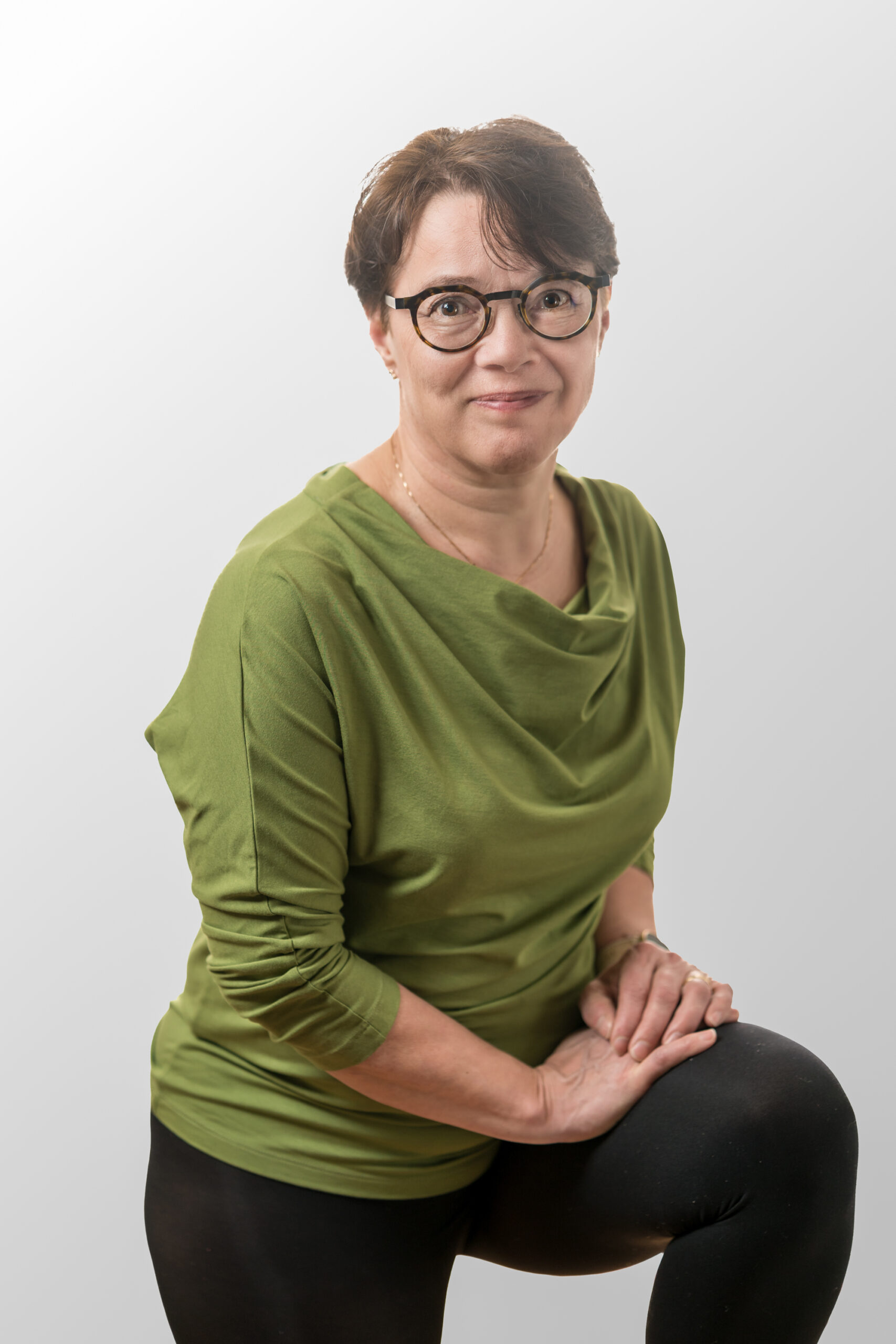 smiling woman wearing white and black pinstriped collared top